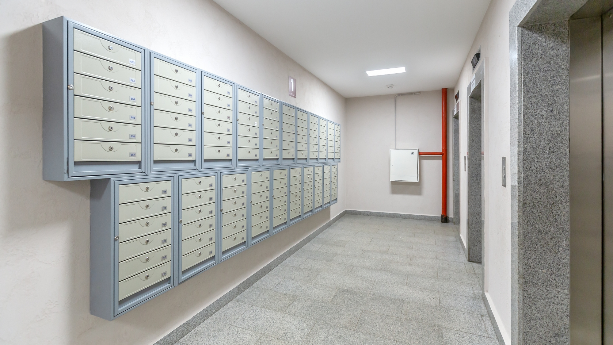 Elevators and mailboxes at the entrance of residential apartment-house.